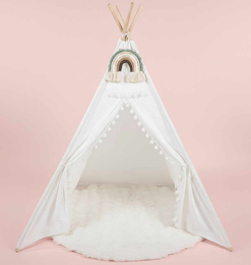 White teepee with a rainbow decoration on a pink background