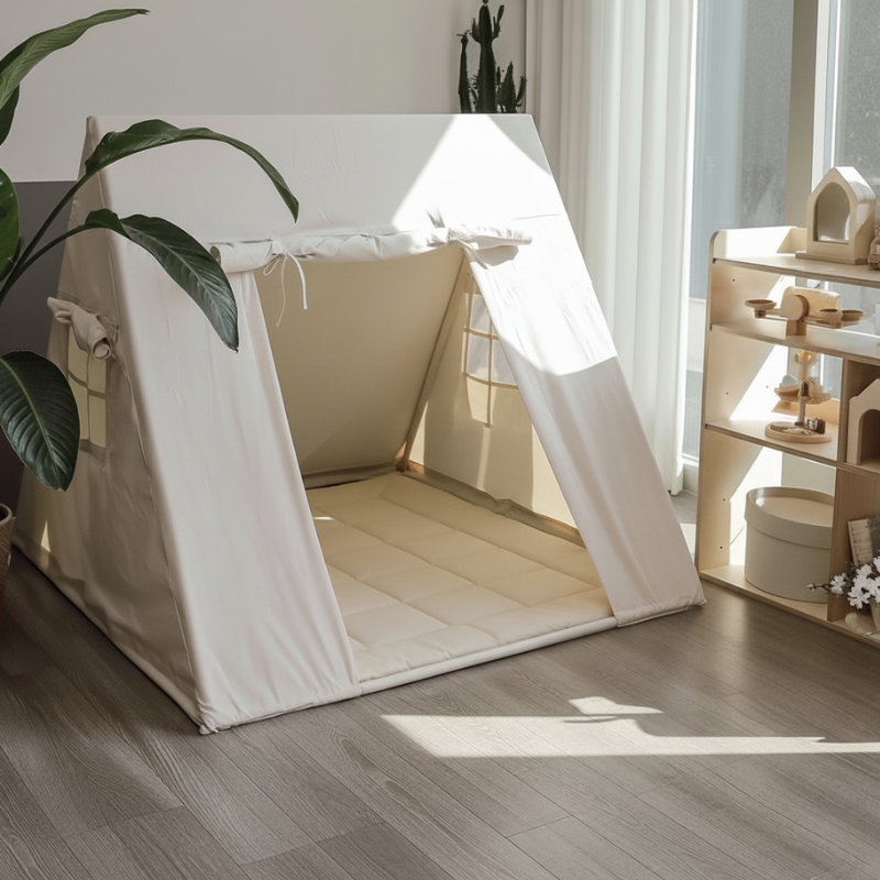 White pet tent on a wooden floor with a plant and shelves in the background