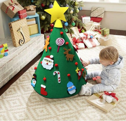 Children's felt Christmas tree with decorations in a living room setting.