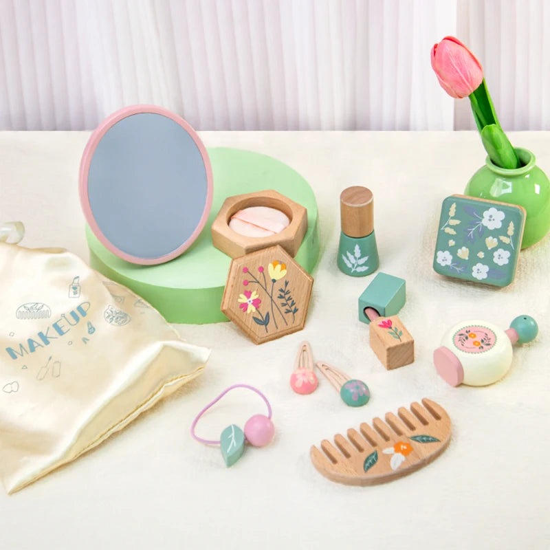 Set of wooden toy makeup and beauty items on a white surface with a light background.