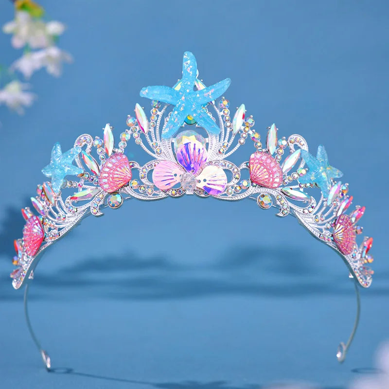 Mermaid-themed tiara with starfish and shell decorations on a blue background