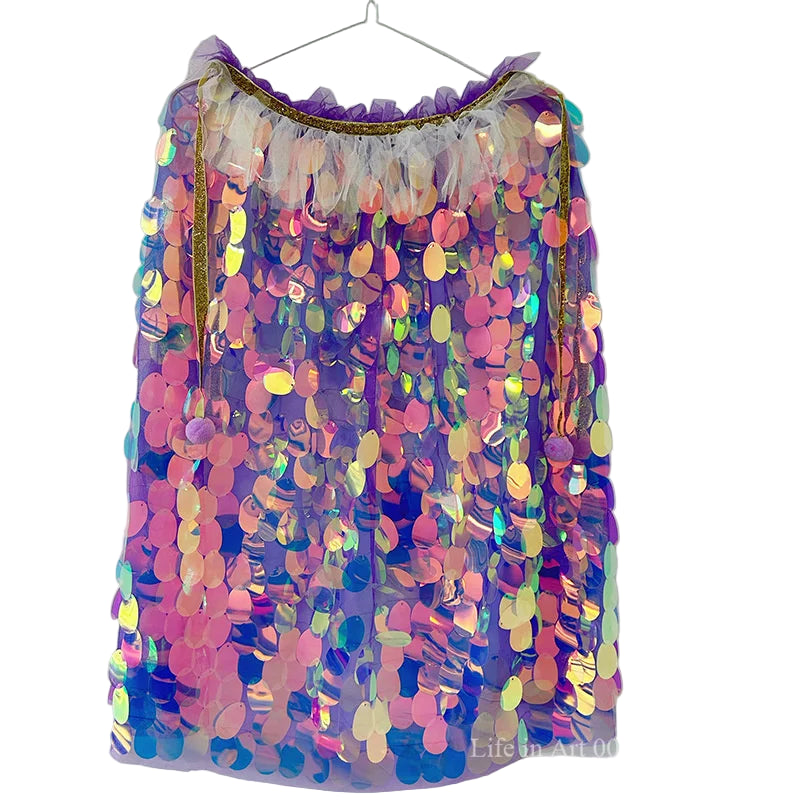 Multicolored sequin skirt on a hanger against a white background